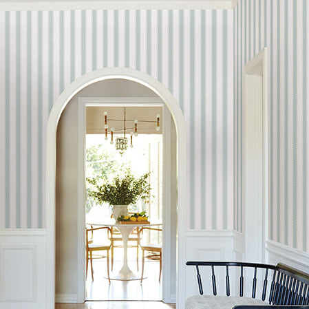 Decorative wall patterns in a room with a bench and table.