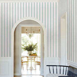 Decorative wall patterns in a room with a bench and table.