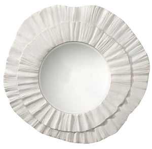 Round mirror with a decorative white frame on a white background