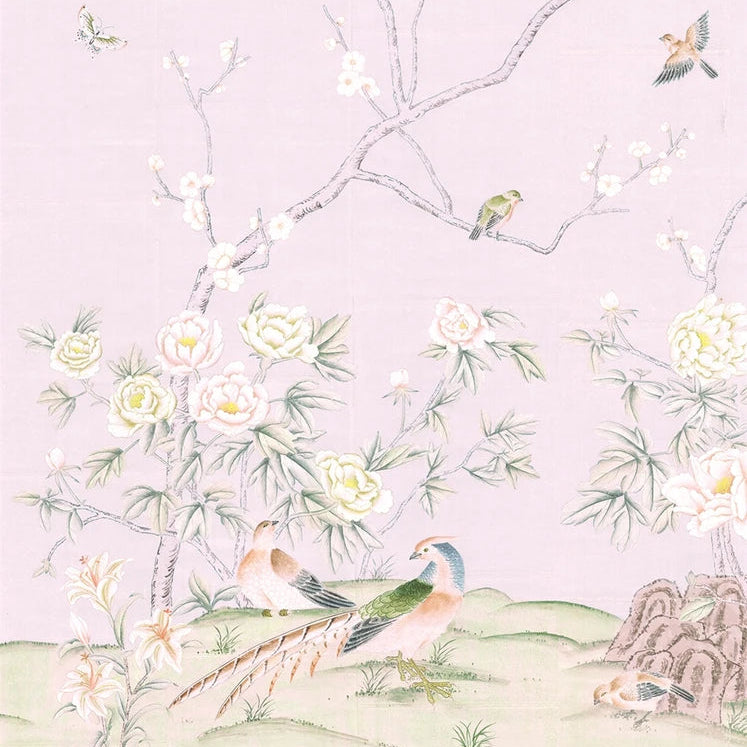 A delicate pastel illustration of a garden scene with peacocks, birds, blossoms, and flowering branches on a pale pink background. The artwork has a soft, vintage aesthetic with muted green foliage, white blossoms, and earthy green hills at the bottom.
