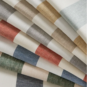 Folded striped fabric in a multicolor palette of beige, gray, blue, green, and terracotta on a white background.