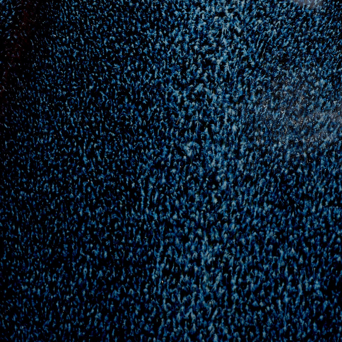 Close-up of blue reactive ceramic glaze
