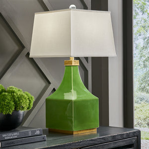 Green lamp on black wooden console 