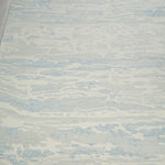 Textured rug with wavy pattern on a wooden floor