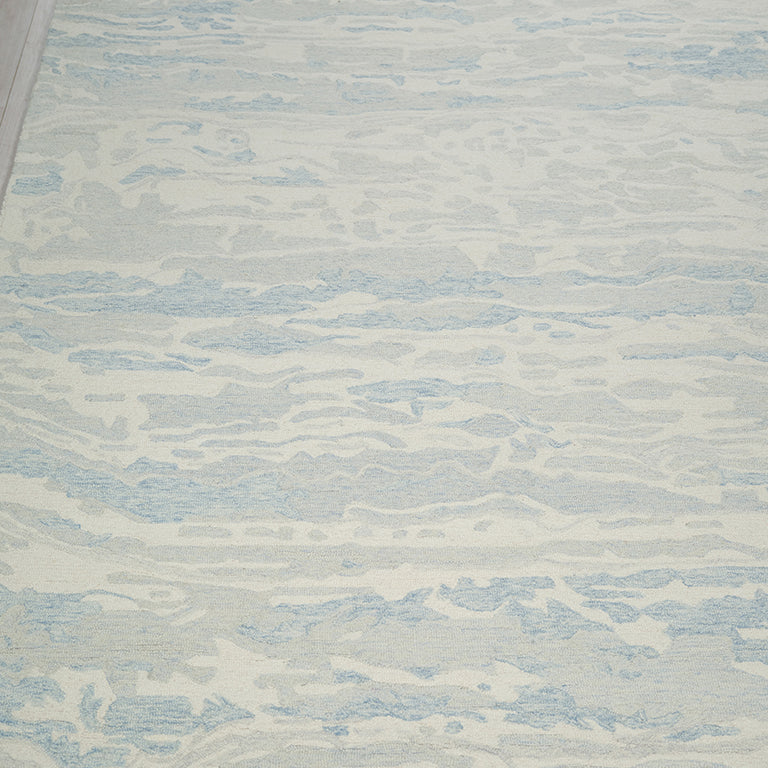 Textured rug with wavy pattern on a wooden floor