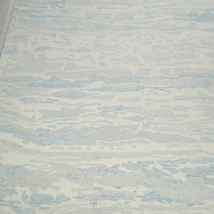 Textured rug with wavy pattern on a wooden floor