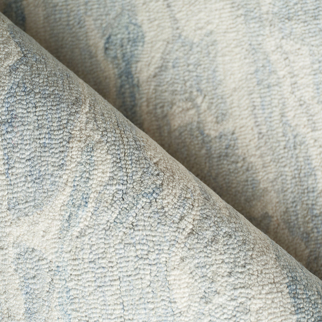 Close-up of textured rug with blue and beige colors