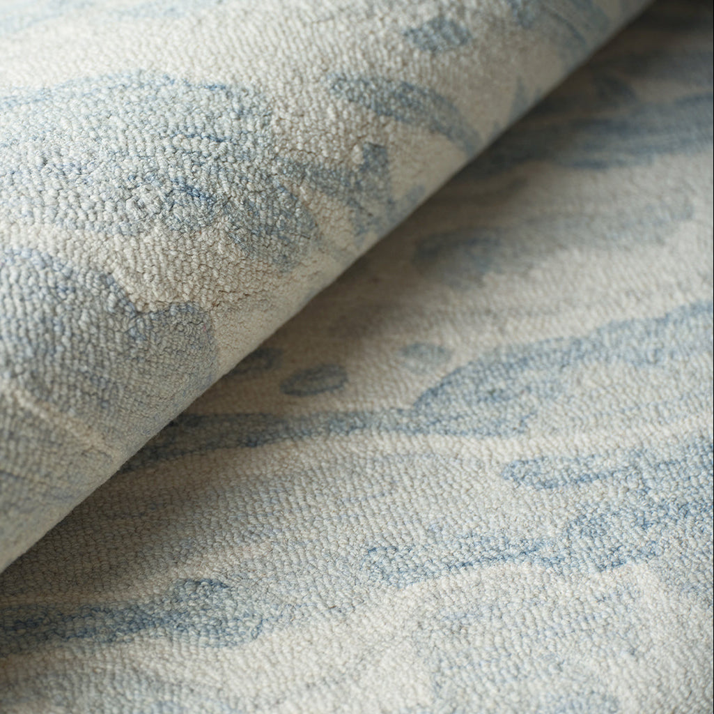 Textured rug with a subtle pattern in blue and neutral tones
