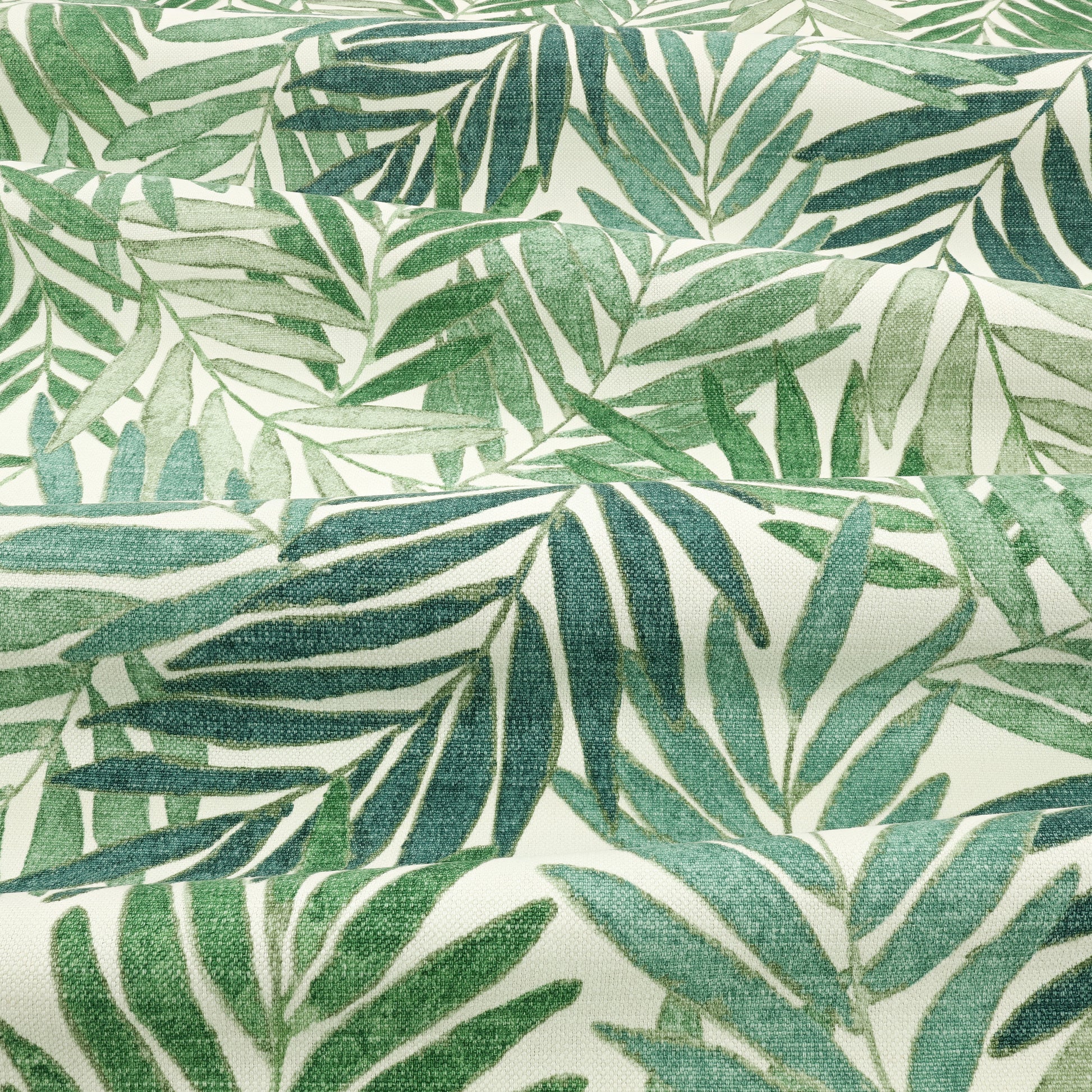 Fabric with green leaf pattern on a white background