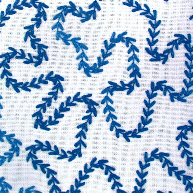 Blue curvy pattern on a white fabric