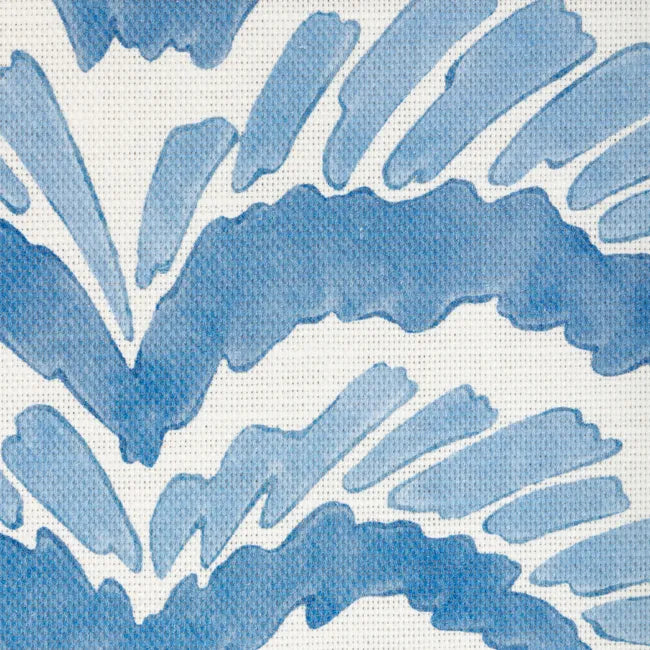 close up of a blue abstract botanical motif on white fabric 
