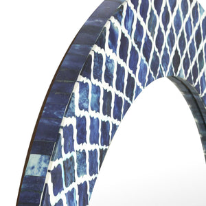 Close-up of a blue and white patterned mirror on a white background