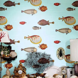 Wallpaper with fish and shell design on a light blue background, with decorative items below.