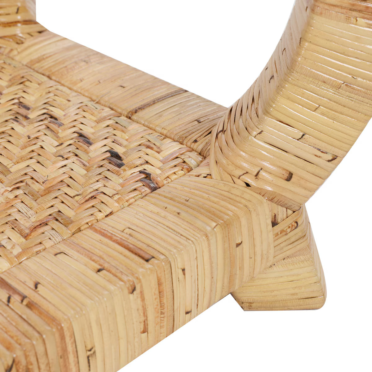 Close-up of a rattan bench corner on a white background