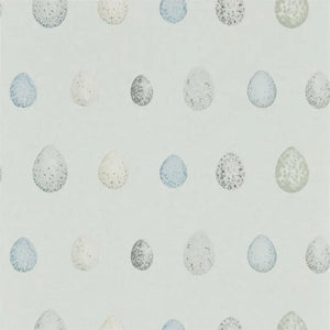 Pattern of speckled eggs on a light blue background