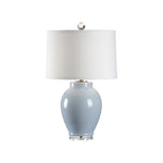 Table lamp with a light blue base and white shade on a white background