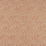 Patterned fabric swatch with a small, repetitive design in orange and beige.