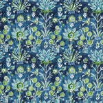Patterned fabric with green floral design on a blue background