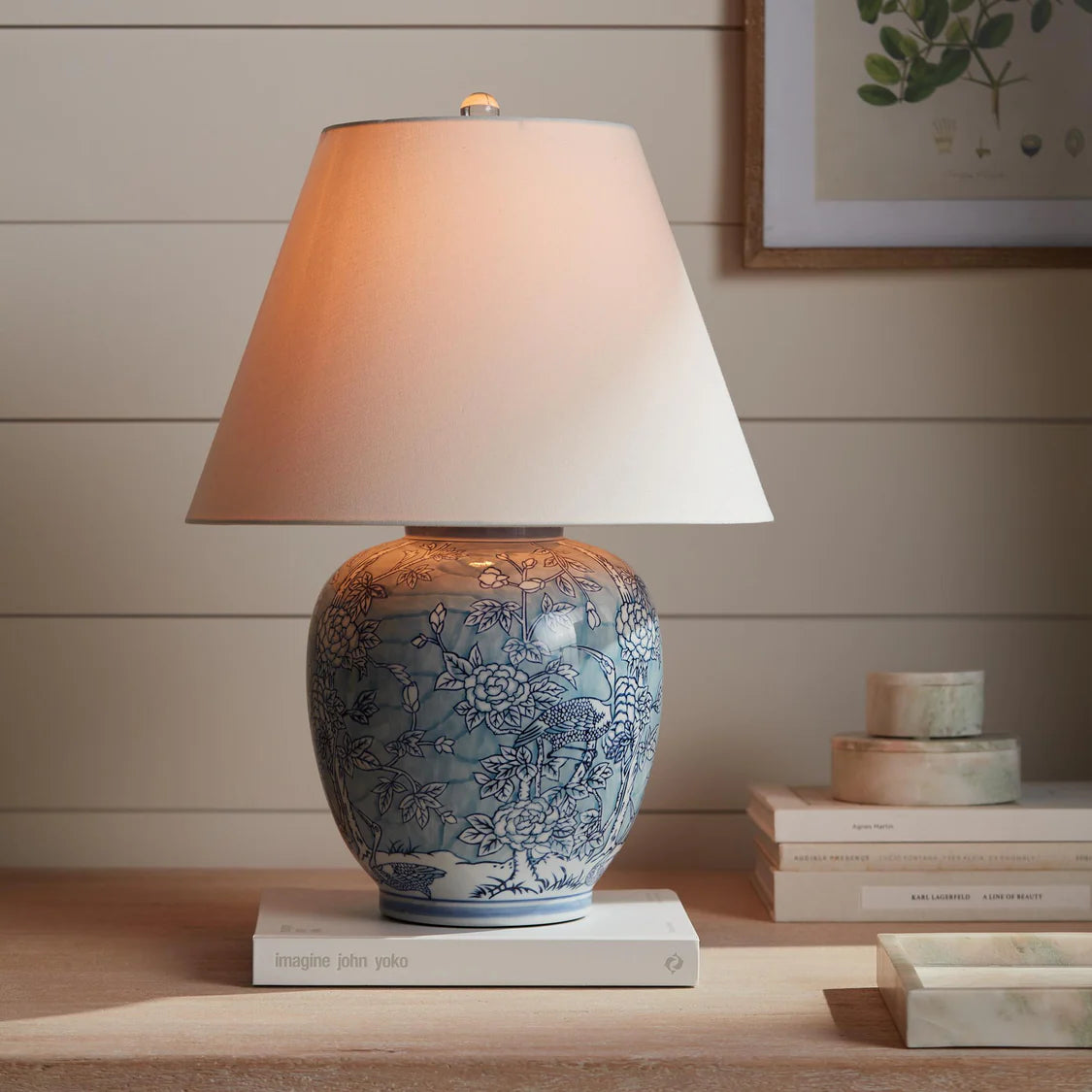 Decorative table lamp with floral patterns on a wooden surface.