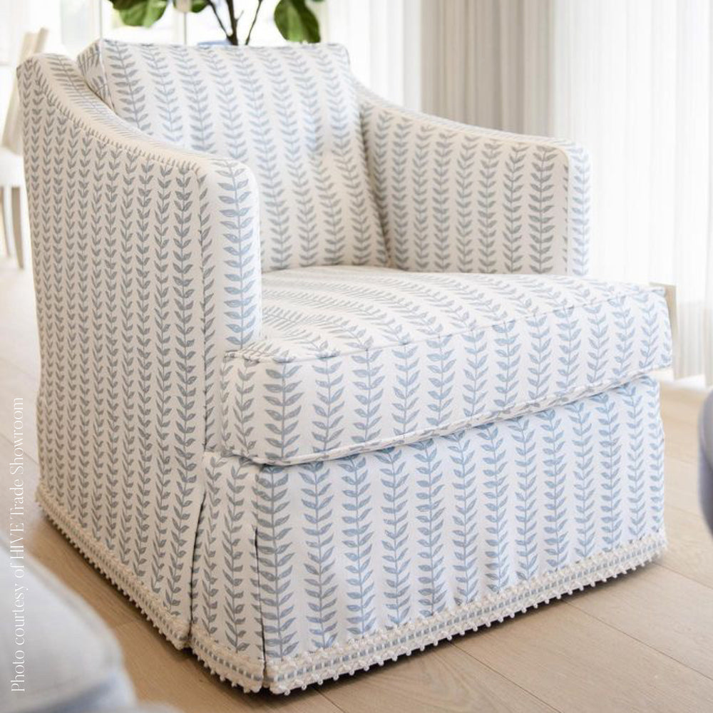 Patterned armchair in a room with light-colored walls and flooring