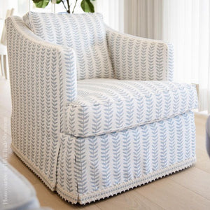 Patterned armchair in a room with light-colored walls and flooring