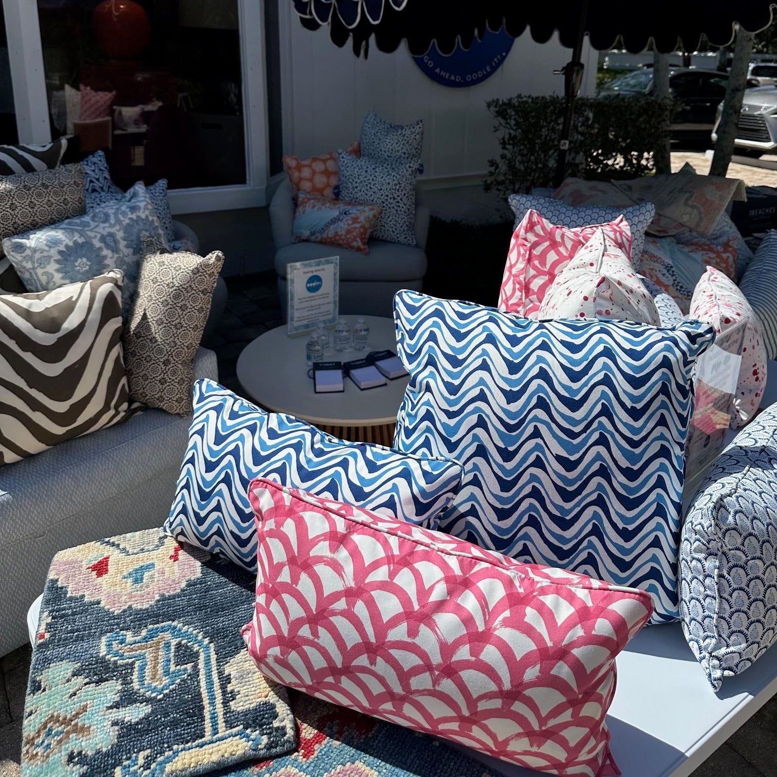 Outdoor patio with colorful cushions and a large umbrella