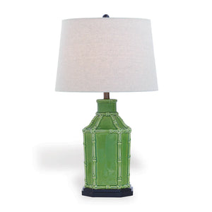 Green table lamp with a white lampshade on a white background