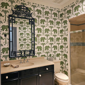 Bathroom with green elephant and palm tree patterned wallpaper, black vanity, and beige countertop.