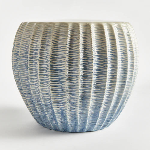 Ceramic stool with ribbed texture on a white background