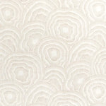Patterned fabric with circular designs on a light background