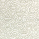 Patterned fabric with circular designs on a light background