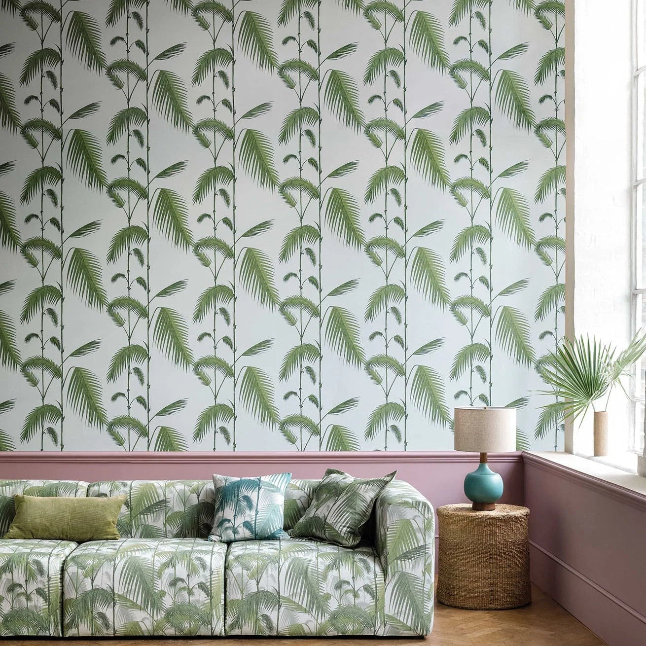 Living room with green leaf-patterned wallpaper, sofa, and rug.