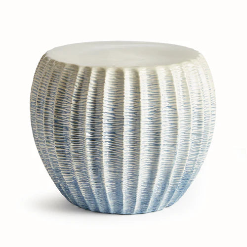 Decorative garden stool with ribbed texture on a white background