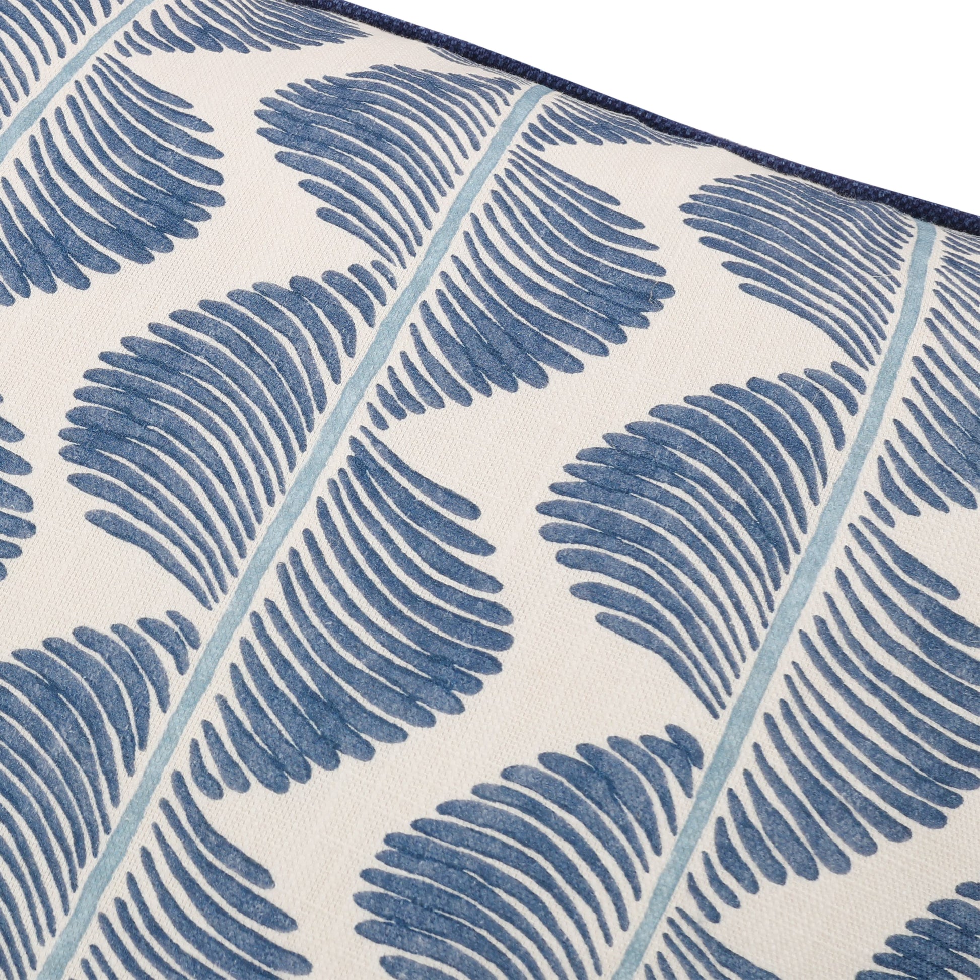 Close-up of a blue and white patterned pillow with leaf design