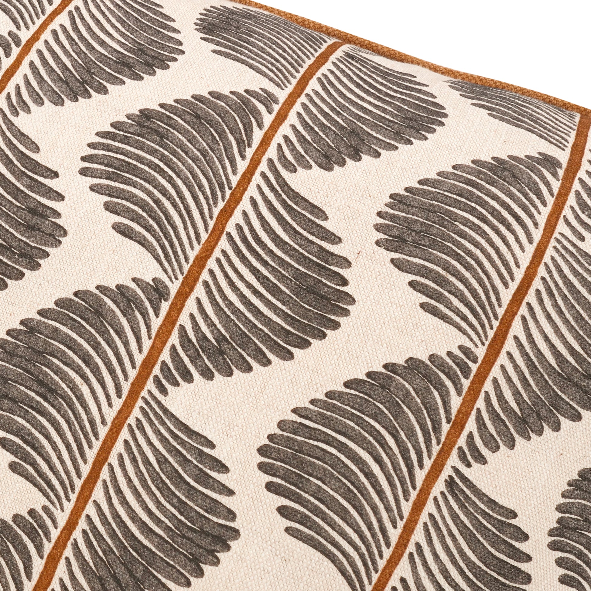 Patterned fabric with brown leaf-like shapes and orange lines on a beige background