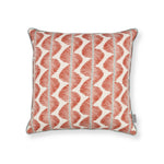 Decorative pillow with red and white pattern on a white background