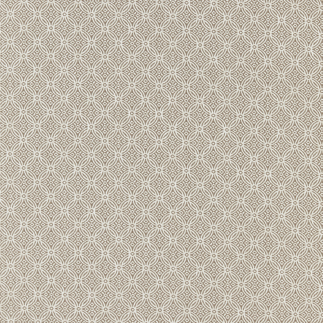 Patterned fabric swatch with a geometric design on a beige background