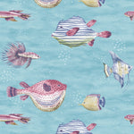 A repeating watercolor-style pattern of tropical fish swimming on a light aqua blue background with subtle white speckles. The fish include pinkish-red pufferfish, striped blue-and-white angelfish, yellow tangs, and other small reef fish.