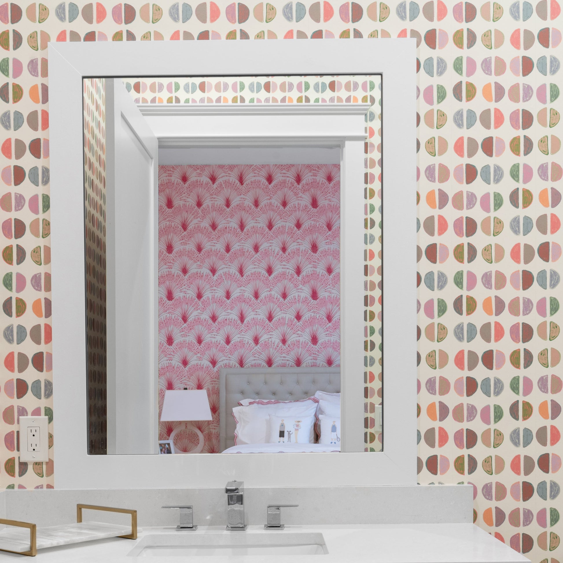 Bathroom vanity with patterned wallpaper and mirror