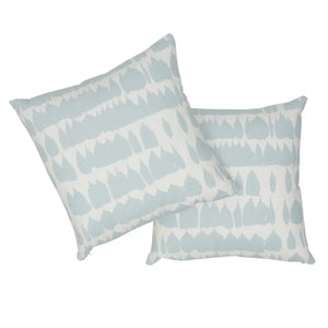Two decorative pillows with a geometric pattern on a white background