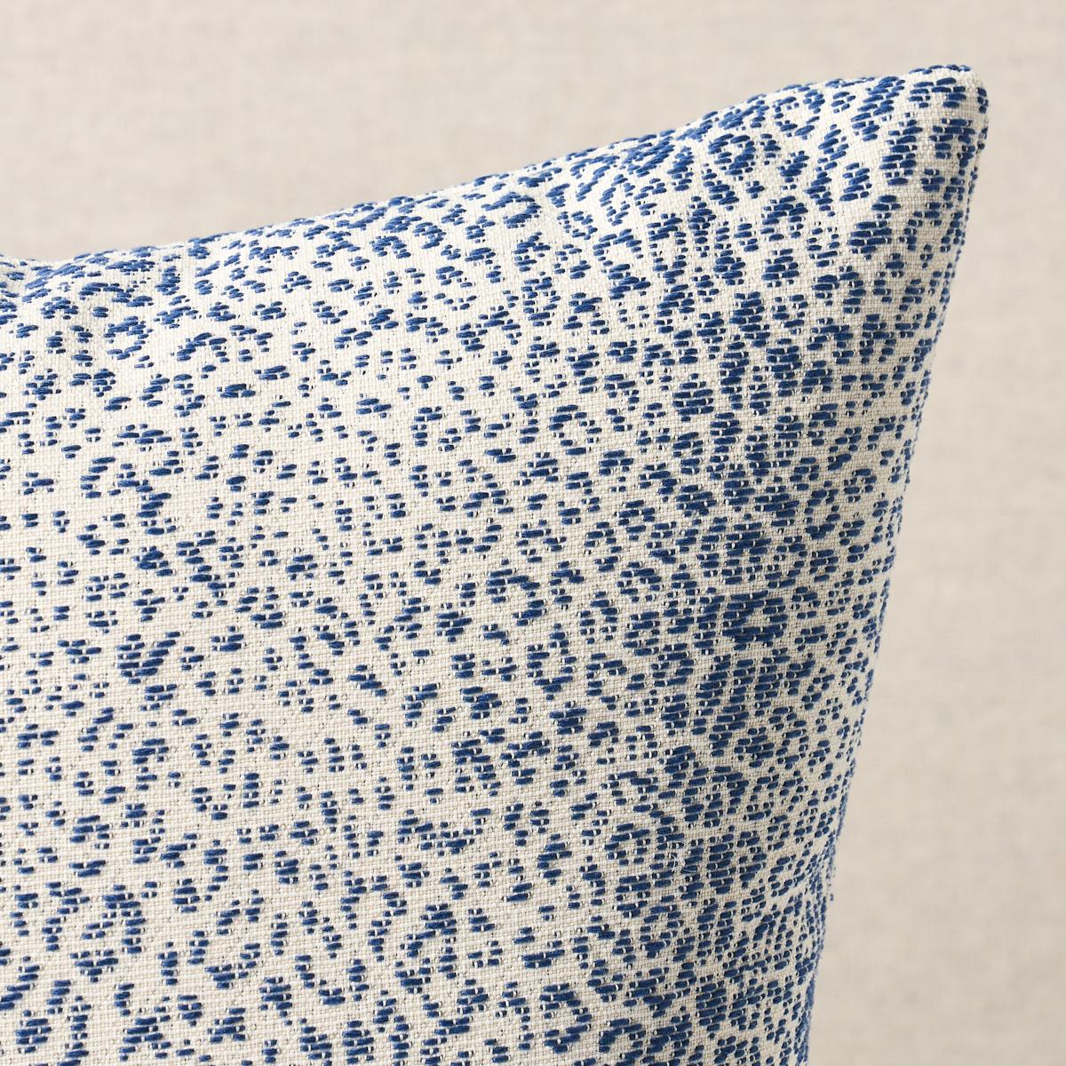 Blue and white patterned fabric on a beige background