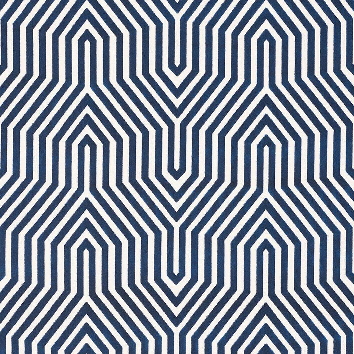 A fabric with a geometric pattern featuring diamonds and triangles in varying shades of blue.
