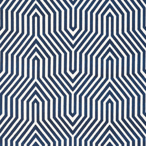 A fabric with a geometric pattern featuring diamonds and triangles in varying shades of blue.