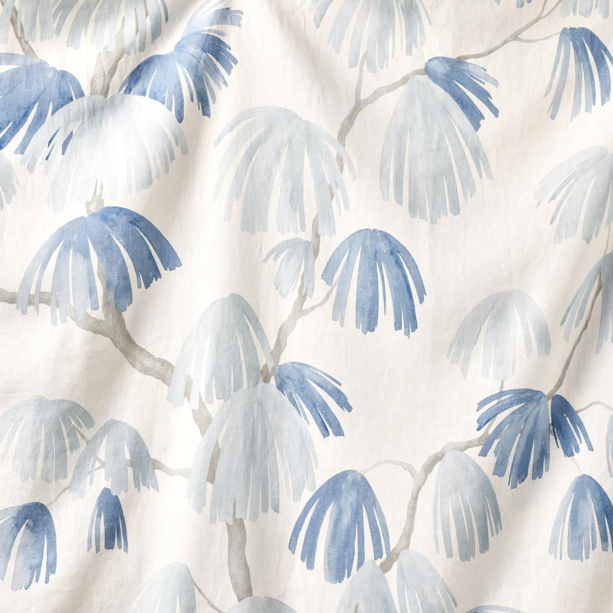 A section of fabric with a pattern of weeping pine trees in blue on a beige background.