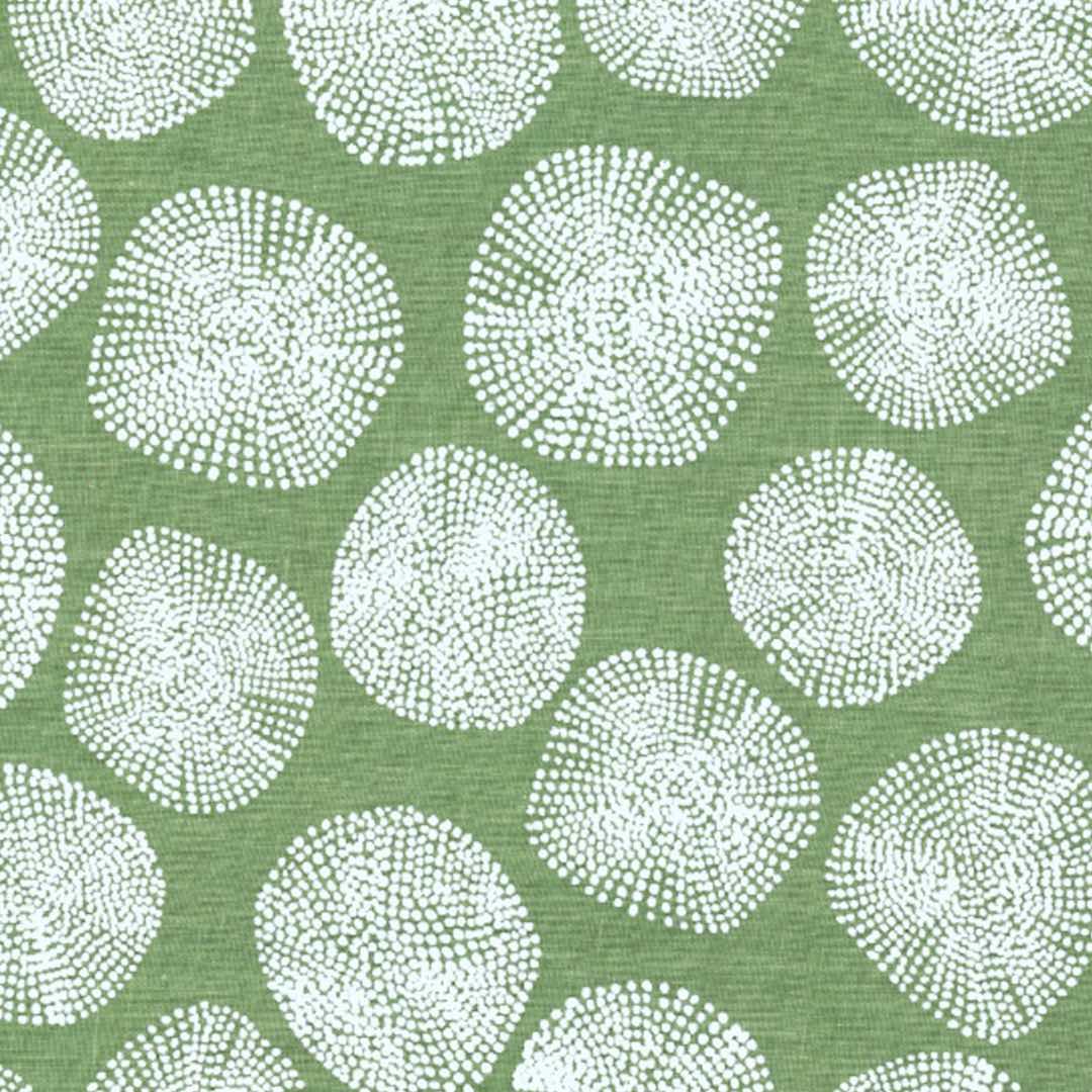 White circular patterns on a green fabric
