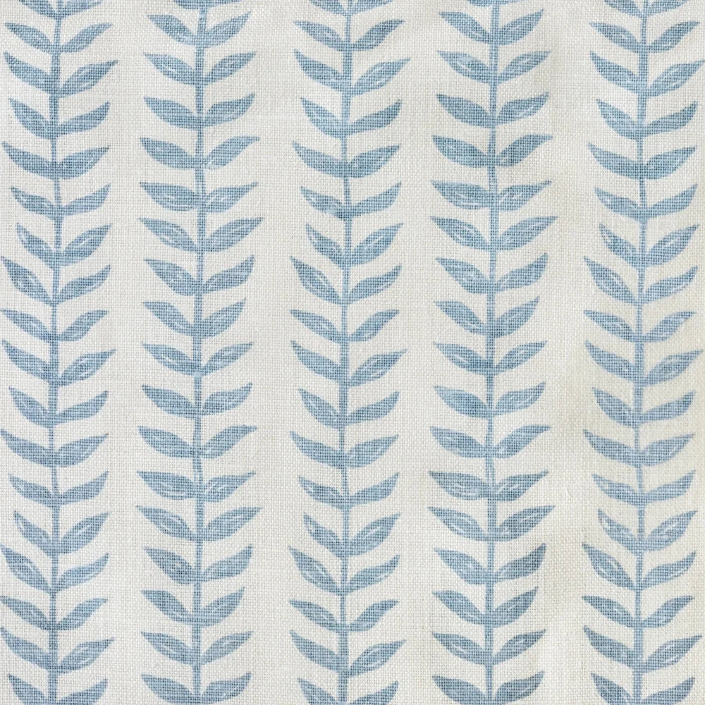 Pattern of blue leaves on a light fabric background