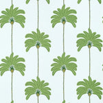 Pattern of green palm trees on a light blue background