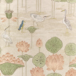 A repeating botanical and bird pattern on a light warm beige background, featuring lotus flowers in soft pink, green lily pads, and several white and blue birds among tall thin tree-like stems.