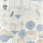 A repeating botanical and bird pattern on a light warm beige background, featuring pale blue lotus pads, blue lotus flowers, and birds in soft blue, gray, and beige tones.