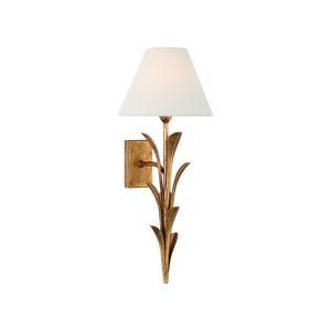 A wall-mounted sconce with a warm gold leaf-like metal frame and a white tapered fabric shade, shown against a plain white background.